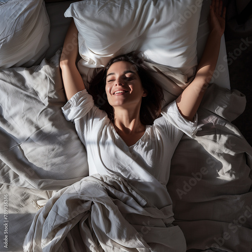Joy of a New Day: Woman in White Bedding Stretching with a Smile © artefacti