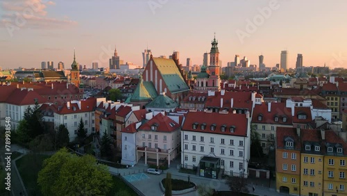 warsaw city old town aerial view drone at sunset rising up revealing castle square and modern business district with high-rise building in the background photo