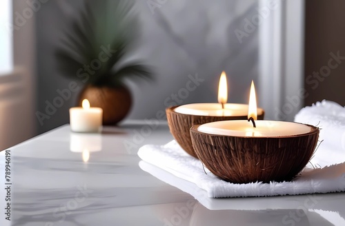 A candle in a coconut against a background of white towels. The concept of relaxation in the spa and cozy ambience in the bathroom