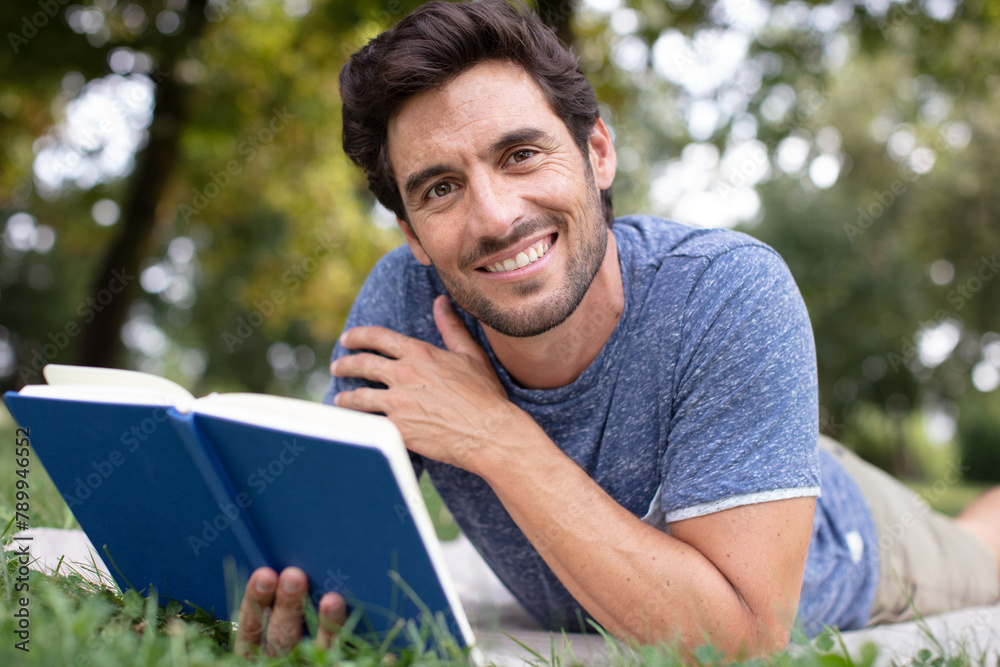 man reading a book on the grass man reading a book on the grass