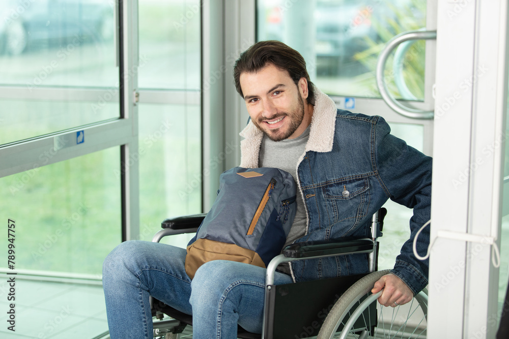 student in wheelchair smiling at the camera student in wheelchair smiling at the camera