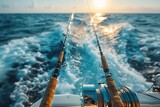 Golden hour light on fishing rods lined up on a boat, against a backdrop of sea spray and sun