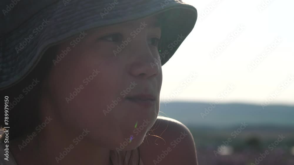 chips, eating - happy Girl enjoys cucumber and chips, in Lavender fields with fragrant purple flowers bloom at sunset, garden setting during daytime, snack time captured.