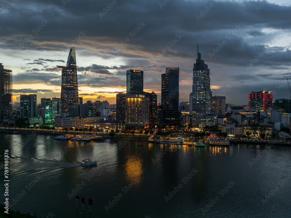 Aerial drone skyline video of Saigon cityscape at sunset in District 1, with Sai Gon river view