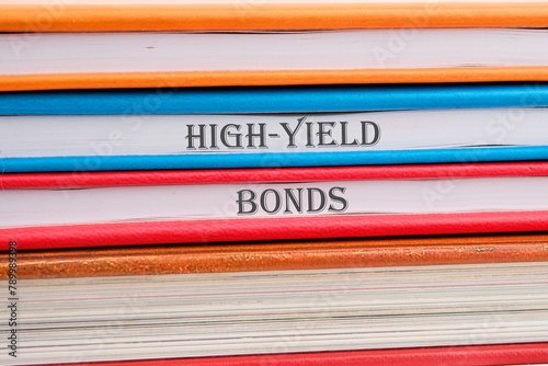 Inscription High-Yield Bonds on notebooks stacked in a pile