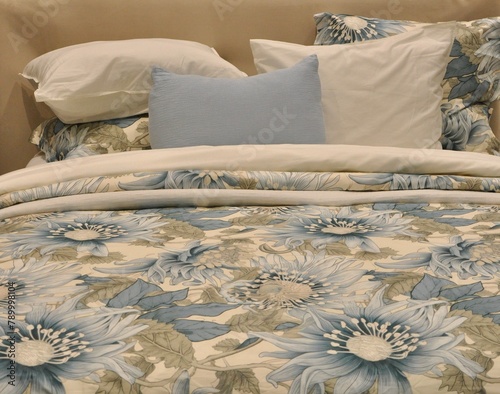 Floral bedroom interior with a double king bed, pillows.The best cushion arrangement in white and blue color.  Blue bedroom with cozy pillow and blanket. Luxury bedroom blue floral style decoration.