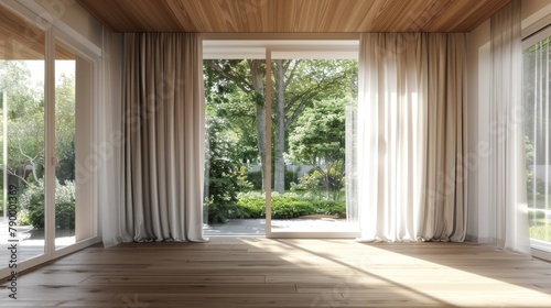 A large open room with white curtains and wooden floors. The room is empty and has a bright, airy feel © Bouchra