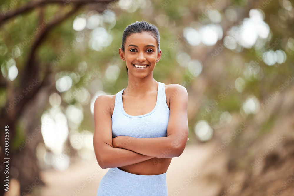 Woman, portrait and athlete for fitness in park, runner and body wellness or health in forest for workout. Sports, exercise and outdoor for vitality, sportswear and confident for training goals