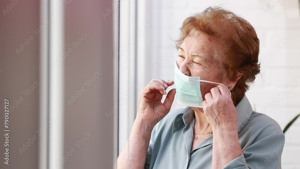 senior woman putting on face mask at home senior woman putting on face mask at home