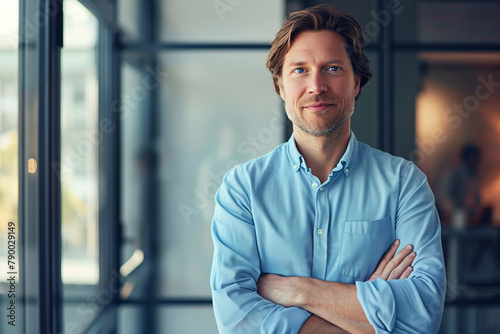 Confident Business Professional in a Blue Shirt Posing in a Modern Corporate Environment 