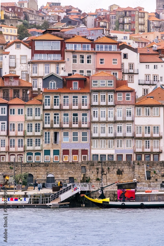 Porto, Portugal Skyline, the old town of Porto from across the Douro River. Colorful houses of Porto Ribeira, traditional facades, old multicolored houses with red tiles during a foggy day, Portugal.