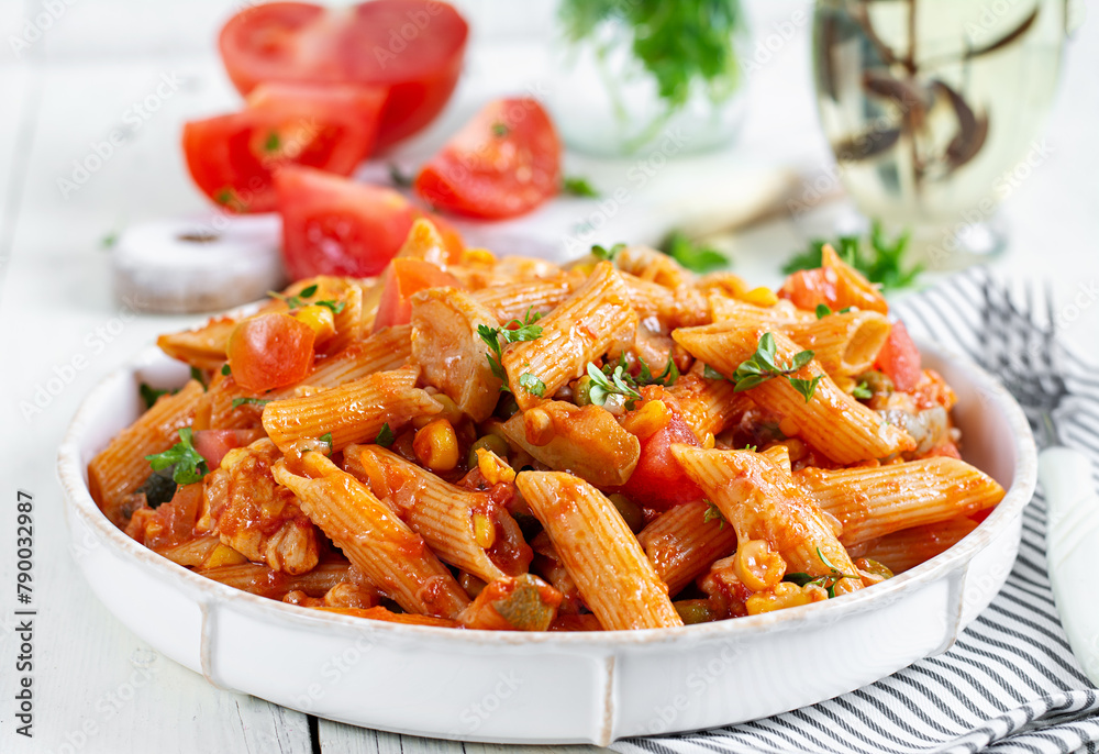 Classic italian pasta penne arrabbiata with vegetables on white wooden table. Penne pasta with sauce arrabbiata. Classic italian pasta penne arrabbiata with vegetables on white wooden table. Penne pasta with sauce arrabbiata.