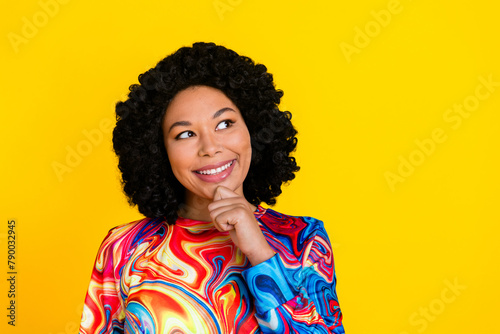 Photo portrait of attractive young woman look minded empty space dressed stylish colorful clothes isolated on yellow color background © deagreez