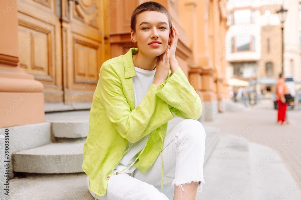 Portrait of a young and attractive woman in casual clothes walking around the city. The concept of fashion, style, youth and lifestyle. Portrait of a young and attractive woman in casual clothes walking around the city. The concept of fashion, style, youth and lifestyle.
