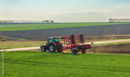 tractor transports a folded plow. before sowing the crop, close up