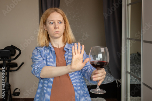 abstinence alcohol, stop liquor, pregnant woman shows a sign of rejection of wine with her hand, refusal of alcoholism