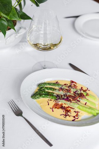 Delicious grilled asparagus with cheese sauce. Food photography, restaurant food presentation.