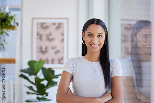 Portrait  smile and business woman with arms crossed in office for career  job or pride in startup company in Dubai. Face  confident professional and happy creative entrepreneur  worker or editor