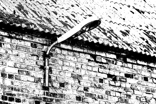 STREET LAMP - Very old and destroyed lantern on an old brick building with an asbestos roof
