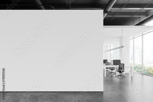 White coworking interior with pc computers on tables near window. Mockup wall