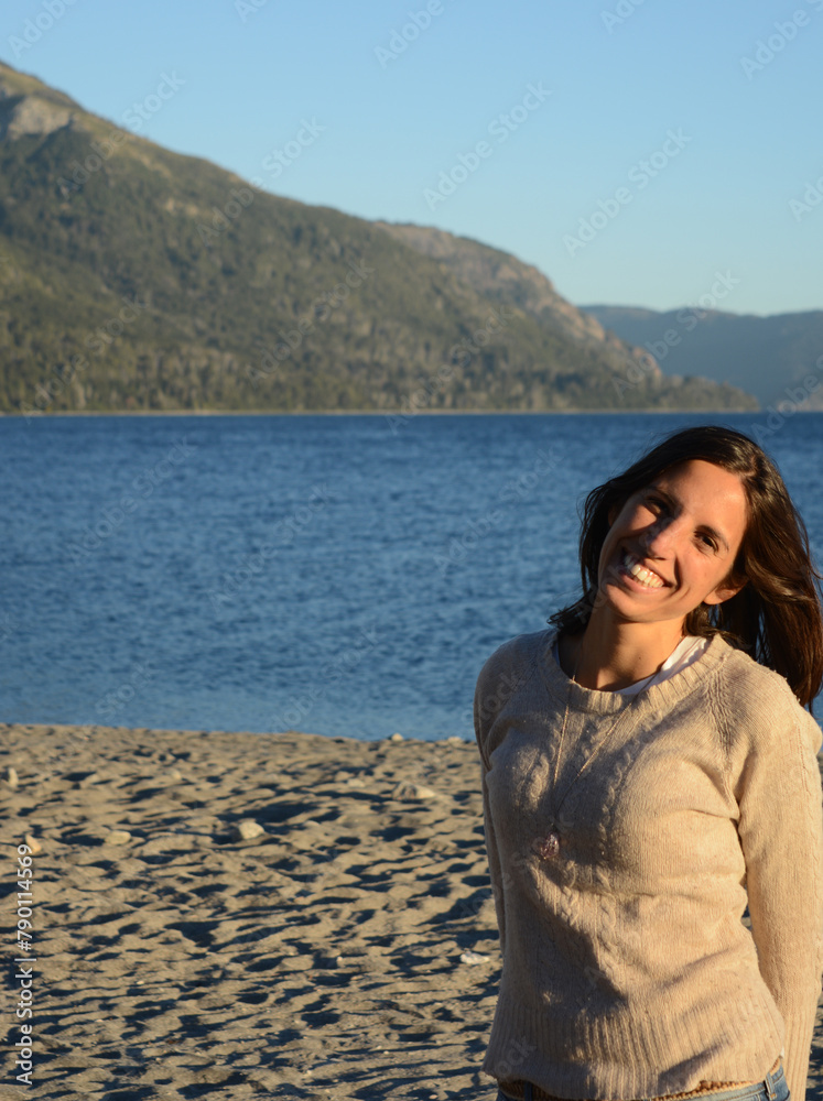 portrait of Latin American brunette woman, with lake and mountains background on vacation enjoying the place portrait of Latin American brunette woman, with lake and mountains background on vacation enjoying the place