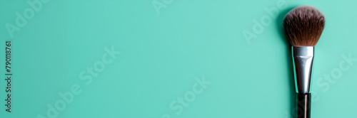 Cosmetic brush web banner. Cosmetic brush isolated on mint green background with space for text.