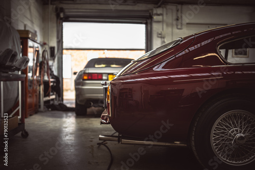 Classic cars being restored in a vintage vehicle garage workshop