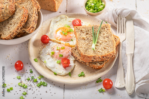 Delicious and crisp breakfast with egg, tomato and bread. © shaiith