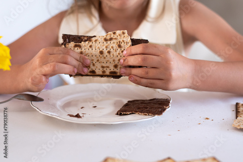 hands of girl hold matzo make sandwich with chocolate. traditional and kosher food for passover. Traditional of Jewish Holiday on Passover. 