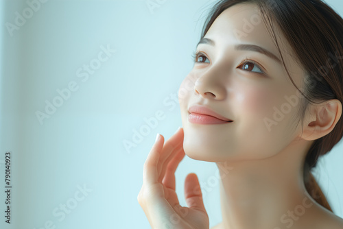Portrait of a serene Asian woman with a subtle smile and clear skin
