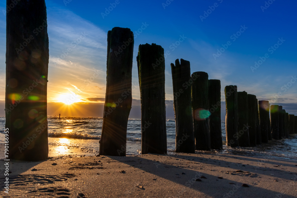 Beautiful golden hour beach sunset with glowing sun and colorful sky ...