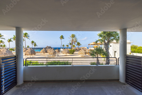 Fototapeta Naklejka Na Ścianę i Meble -  Beautiful view from the hotel room balcony overlooking the sandy beach Caribbean beach and volleyball court. Curacao.