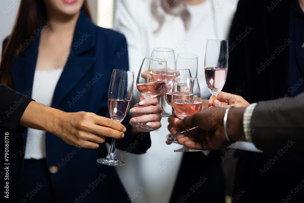 Closeup hand holding glassware. Business people celebrate making a toast on event party at office. Celebration Success Concept Closeup hand holding glassware. Business people celebrate making a toast on event party at office. Celebration Success Concept