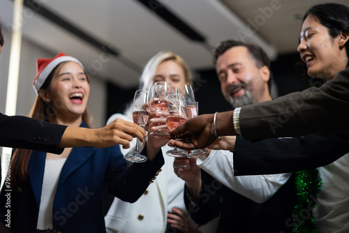 Closeup hand holding glassware. Business people celebrate making a toast on event party at office. Celebration Success Concept