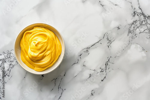 cup of hot and tasty yellow dijon mustard paste, top view, free copy space for text photo