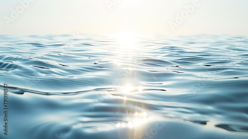 Calm blue water surface with sunlight reflecting, creating a tranquil scene. photo