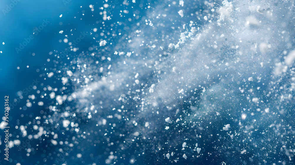 White snow flurry isolated on blue background. cold snowflakes with crystals and specks in the air. Winter concept for design banner White snow flurry isolated on blue background. cold snowflakes with crystals and specks in the air. Winter concept for design banner