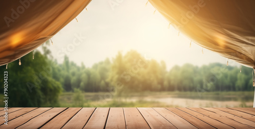 Wooden table on blur tent camping at day background