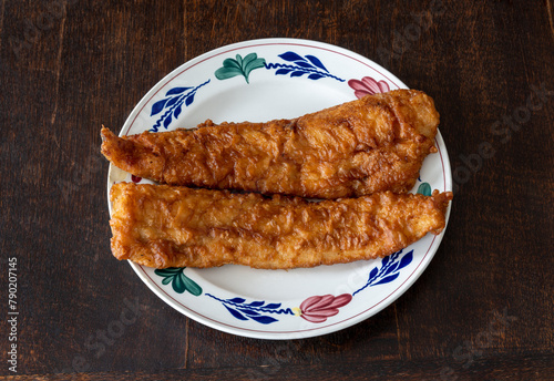 Lekkerbek on the plate, deep fried fish fillet and a typical dutch street food