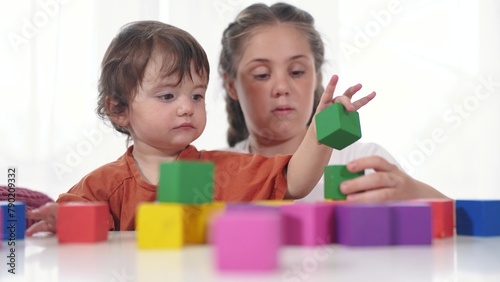 child baby group playing cubes close-up. education a children development of fine motor skills concept. child baby group close-up hands lifestyle plays with blocks develops fine motor skills