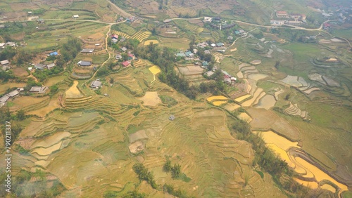 Top view of terraced paddy field and traditional houses of Muong Hoa valley, Fansipan mountain, Sa Pa town, Vietnam. photo