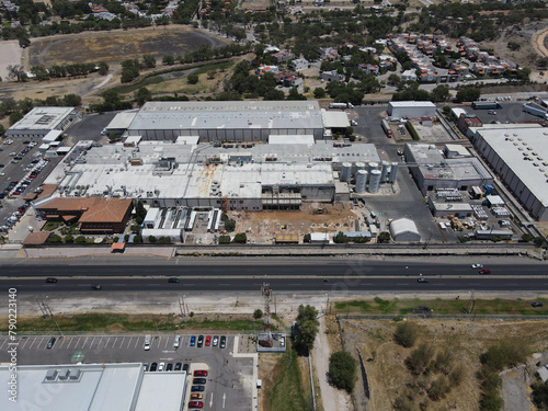 Aerial view of the goods warehouse. Logistics center in the industrial area of the city with a lot of roads, construction.