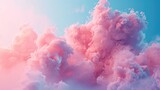 Playful puffs of pink clouds drift across a clear blue sky background, a relaxing dreamy atmosphere