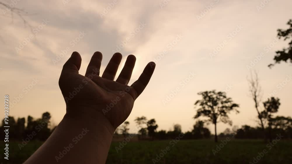 Hand Rises From Sun For Help Stretches his hand in the sun. Faith in god dream a religion concept ...