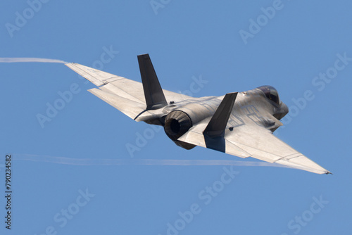 Tail view of a F-35C Lightning II  with trails at the wing  tips 