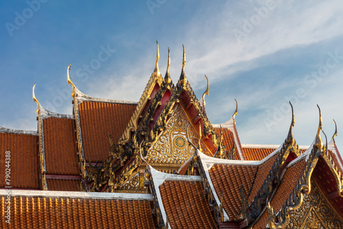 Decorative rooftop in red tile and golden trim, at the Marble Temple (Wat Benchamabophit Dusitvanaram), Bangkok, thailand.
 photo