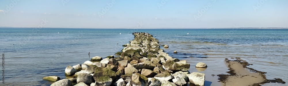 Stones on the seashore - a pier path made of stones Stones on the seashore - a pier path made of stones