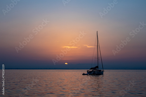 Yacht at anchor  along the West Coast of Sardinia  at sunset