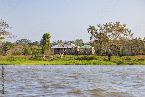 Scenic view of houses along San Juan river also known as El Desaguadero at the border of Costa Rica and Nicaragua photo