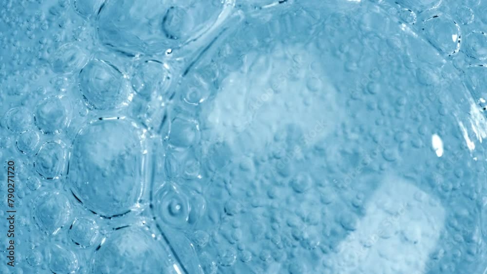 Oxygen bubbles in water on a blue abstract background on super slow motion. Oxygen bubbles in water on a blue abstract background on super slow motion.